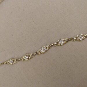 Silver tone metal link bracelet with clear stone clusters.